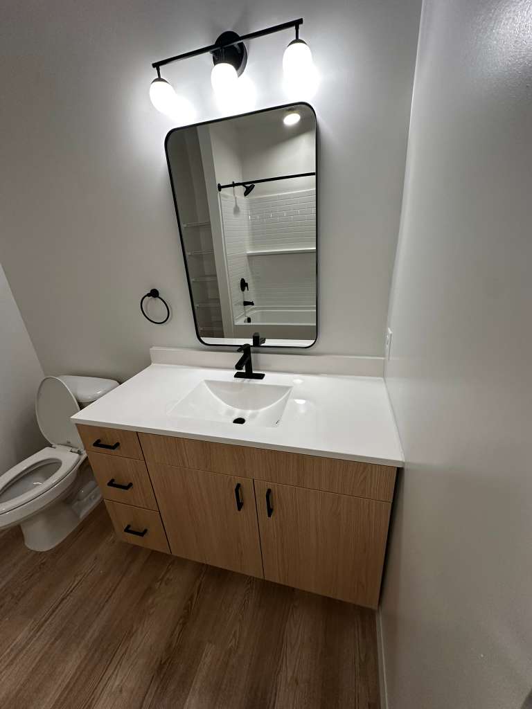 Modern bathroom vanity and mirror cleaned to a spotless shine in a Southwest Florida home